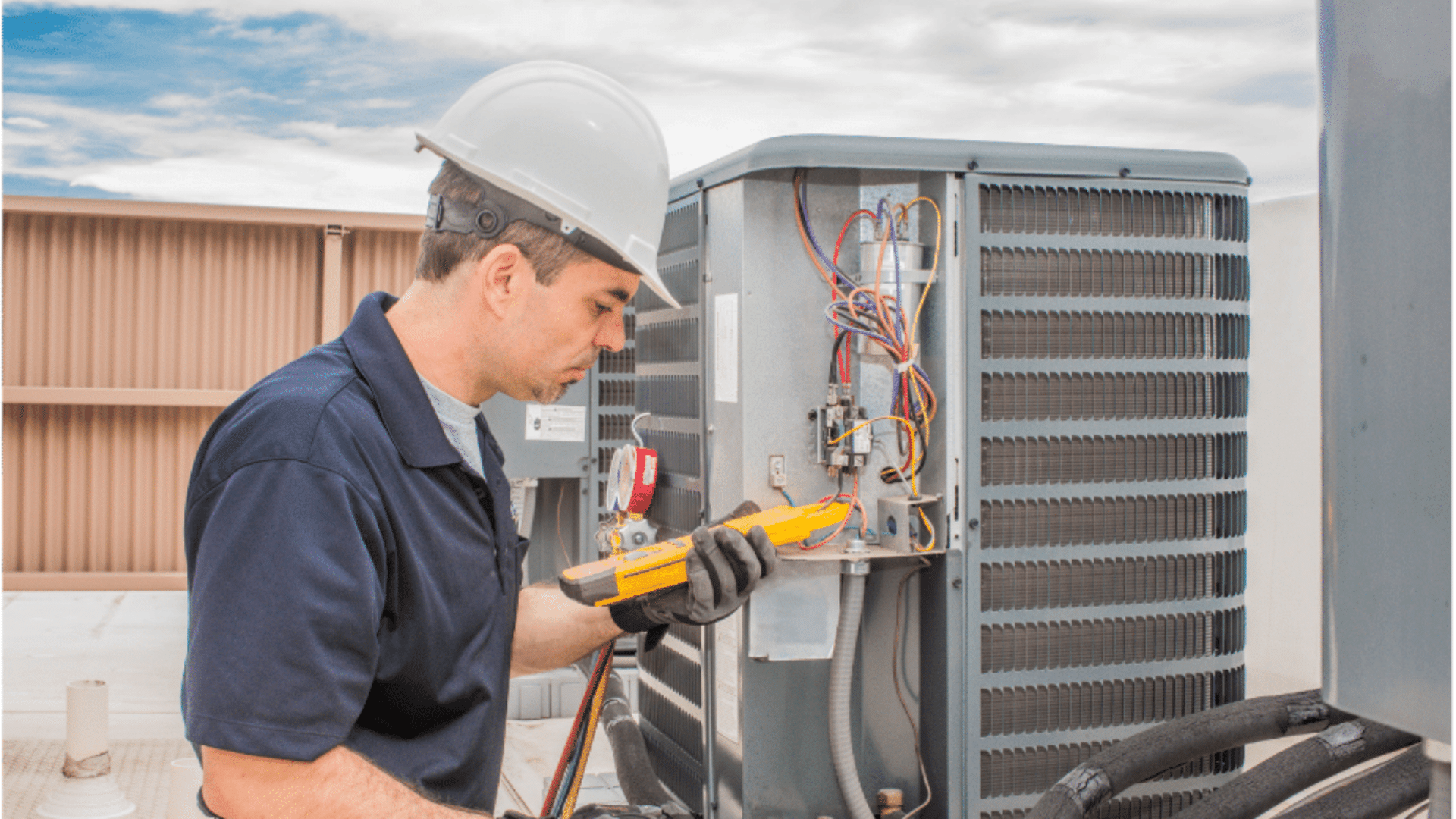 Technician inspecting HVAC unit on rooftop with a multimeter.