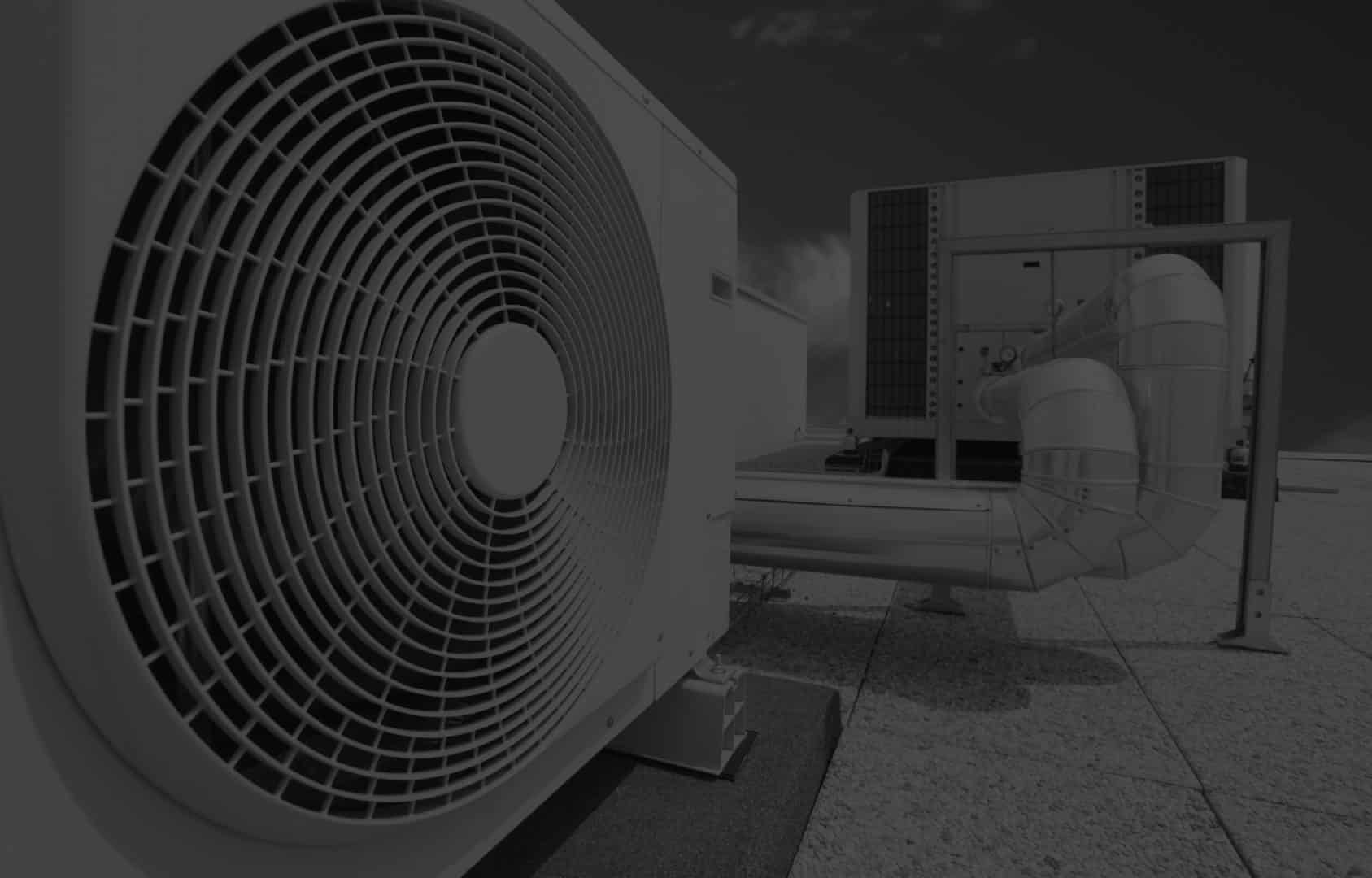Industrial rooftop air conditioning unit with large fan and ducts.