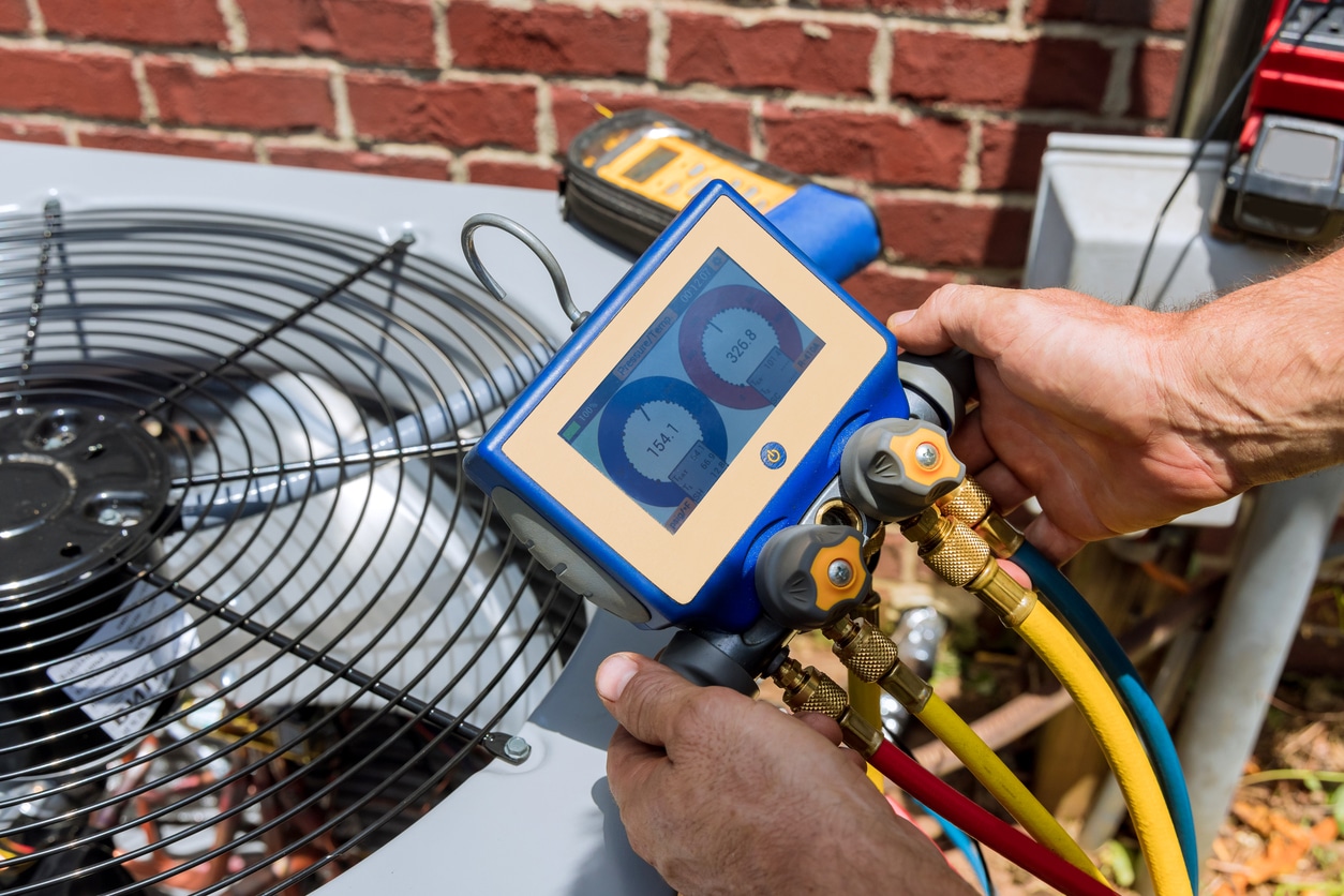 A certified technician checks refrigerant levels during a spring AC tune-up service in Middle Tennessee.