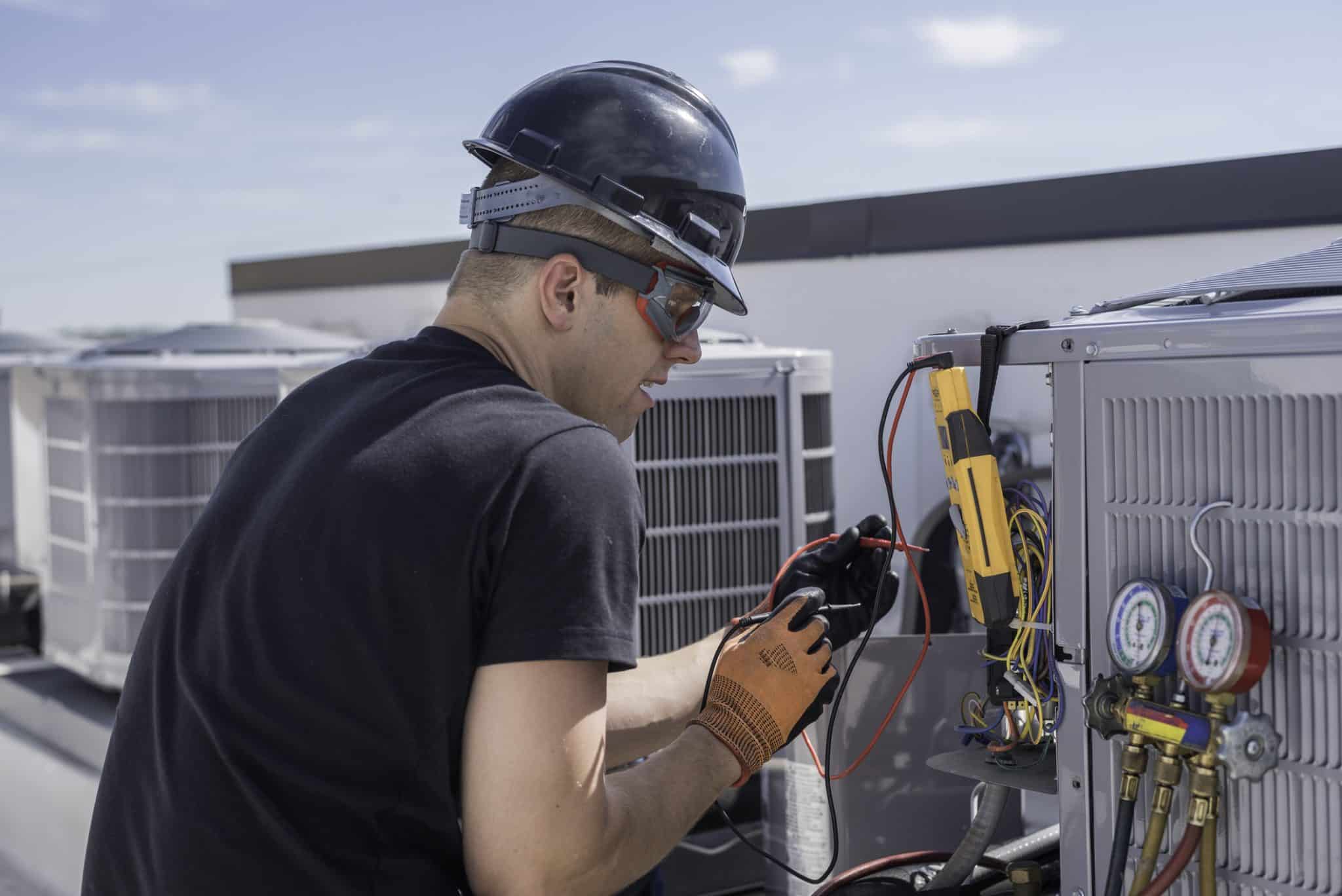 An HVAC technician performs commercial AC maintenance, keeping a Nashville small business cool and running efficiently.